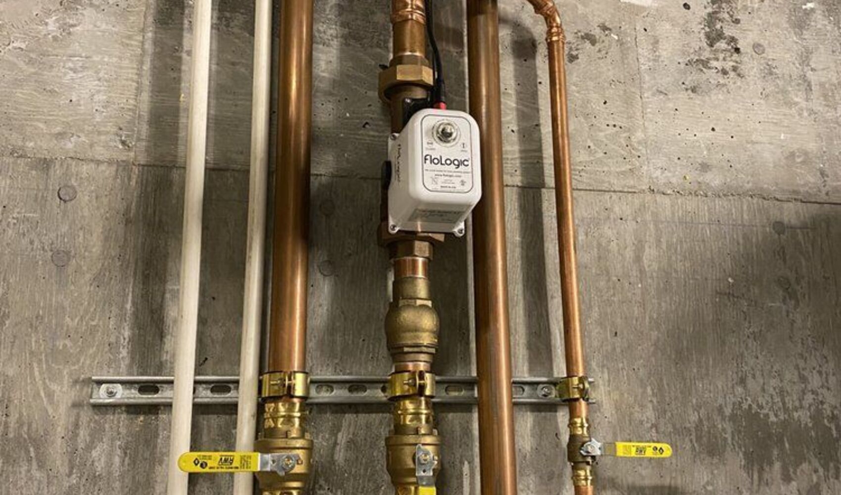 Copper manifold with isolation and bypass valves on a mechanical wall